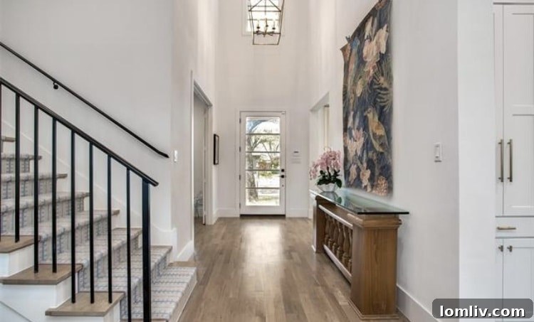 Spacious living room with white oak floors and modern fireplace in a Dallas custom home