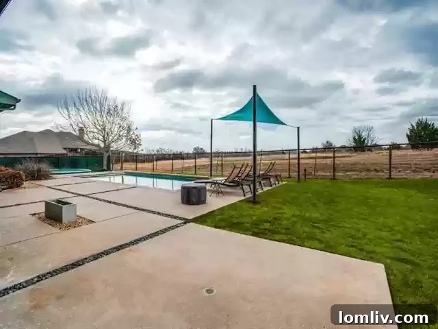 Spacious covered patio with outdoor fireplace and grilling station