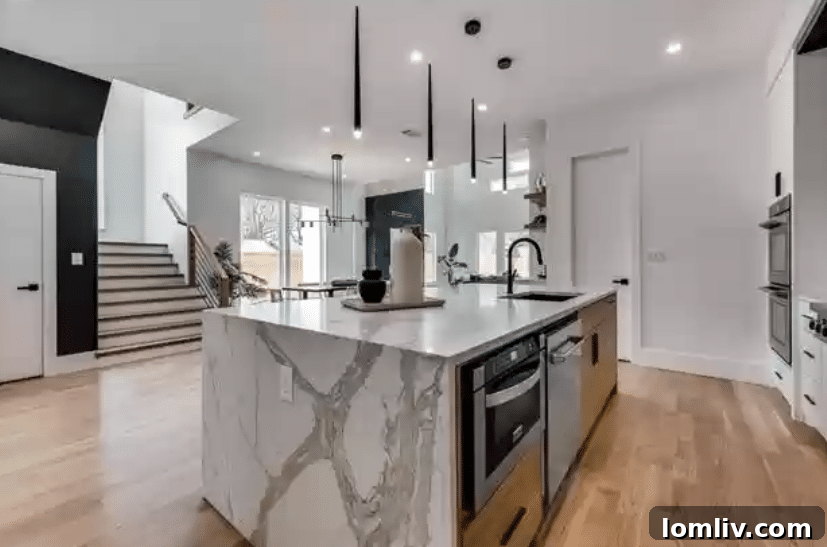 Luxurious white oak flooring and custom quartz countertops enhance the open living spaces.