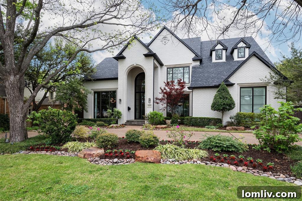 Expansive front view of the luxury Dallas home at 6049 Glendora, highlighting its elegant facade and manicured landscape.