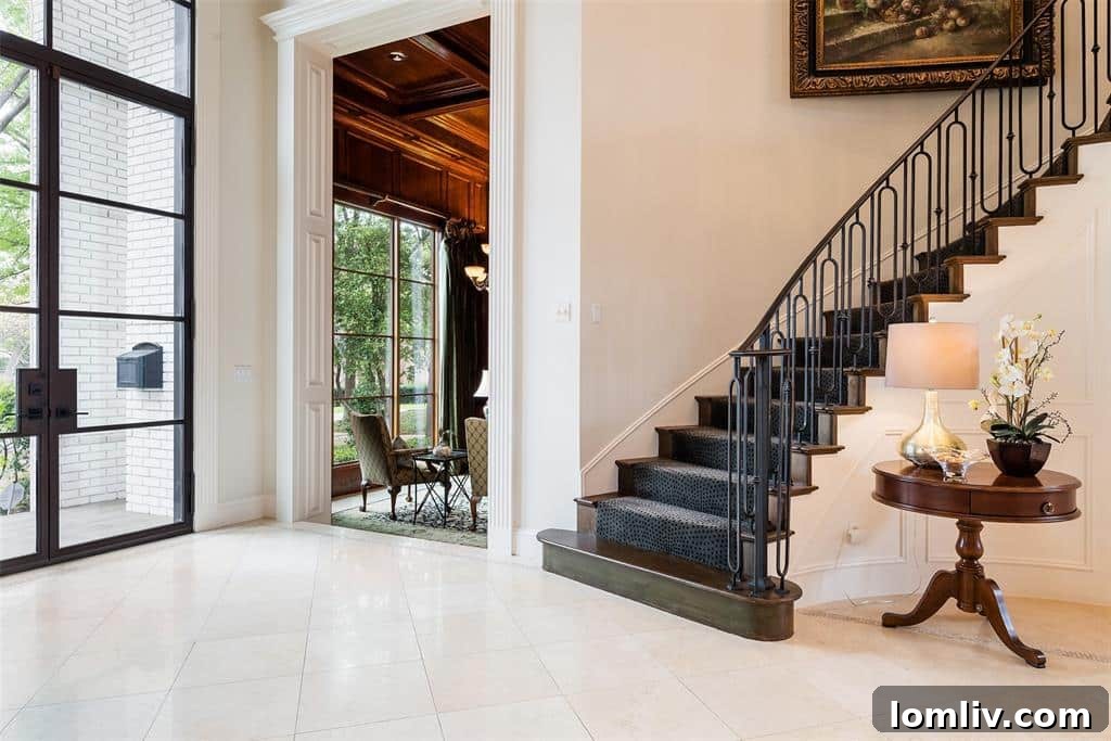 The grand living room of 6049 Glendora, featuring high ceilings, elegant furnishings, and views of the stunning backyard oasis.