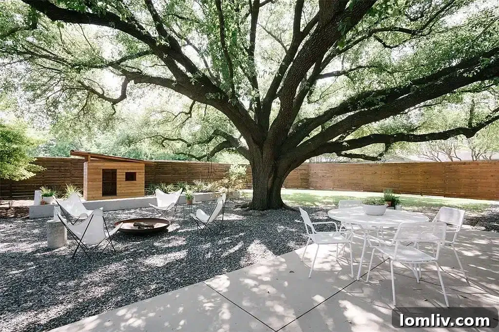 Inviting outdoor fire pit area under a large oak tree in a Midcentury Modern backyard
