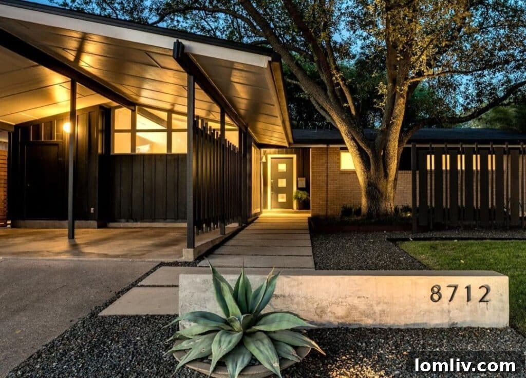 Expansive living area showcasing Midcentury Modern furnishings and large windows