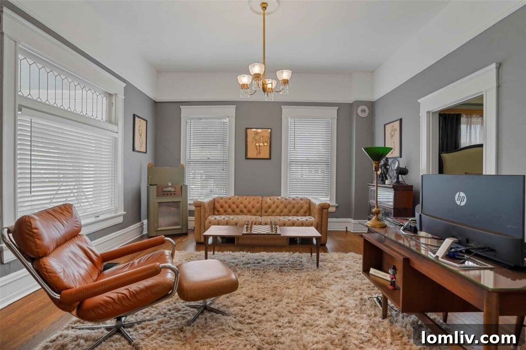 Spacious Living Area with Original Oak Floors and Vintage Windows