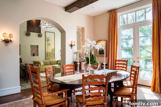Dining room opening to covered porch overlooking pool and gardens