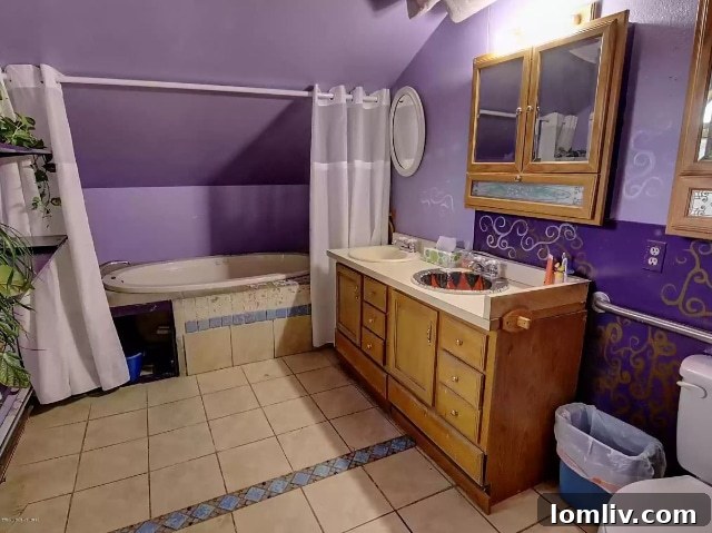 A unique bathroom in the Talkeetna home featuring a bathtub tucked under a slanted ceiling.