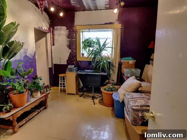 The living room of the Talkeetna home, showing existing decor and clear potential for renovation.