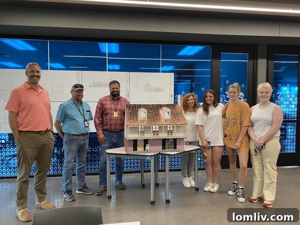 Brett Holzle, Jim Bagby, Patrick Surratt, Yvette Hightower (HP MAPS architecture teacher), Avery Allday, Hannah Henchot, Meg Peters (3 students) posing with the playhouse project.