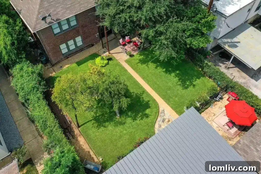 Expansive and beautifully landscaped backyard with various seating areas