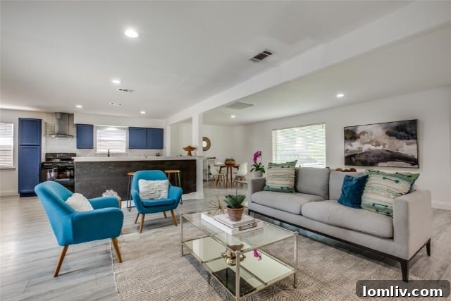 Poolside Perfection: Everything About This Home 5 Bright and airy open-concept living room with updated flooring and fireplace in Richardson home