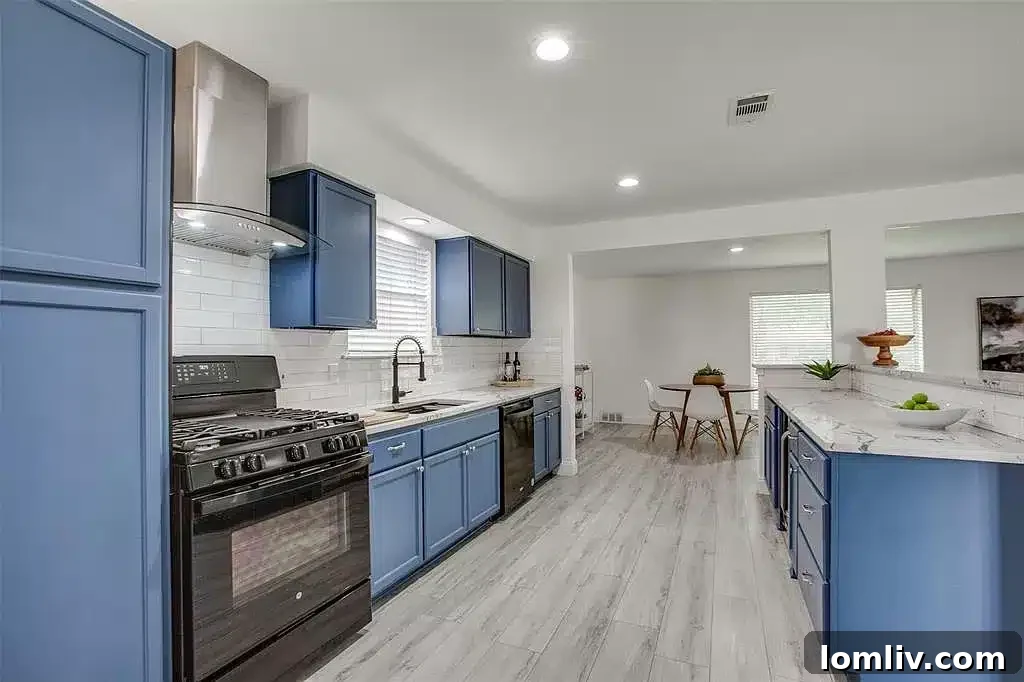 Poolside Perfection: Everything About This Home 6 Modern kitchen with blue cabinets, subway tile backsplash, and open shelving in East Richardson
