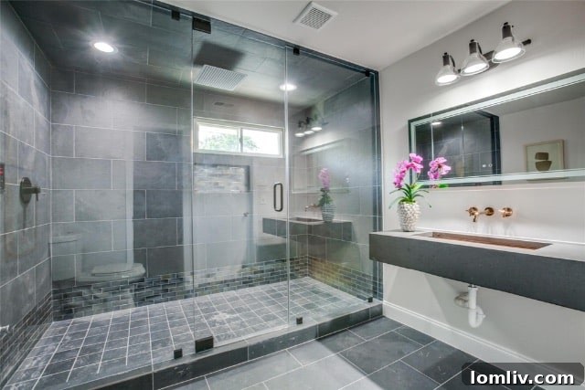 Poolside Perfection: Everything About This Home 8 Luxurious primary bathroom with oversized shower and modern floating vanity in Richardson