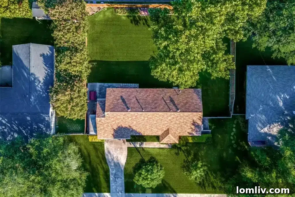 Front view of the property at 9922 Donegal Drive, nestled under a large sycamore tree