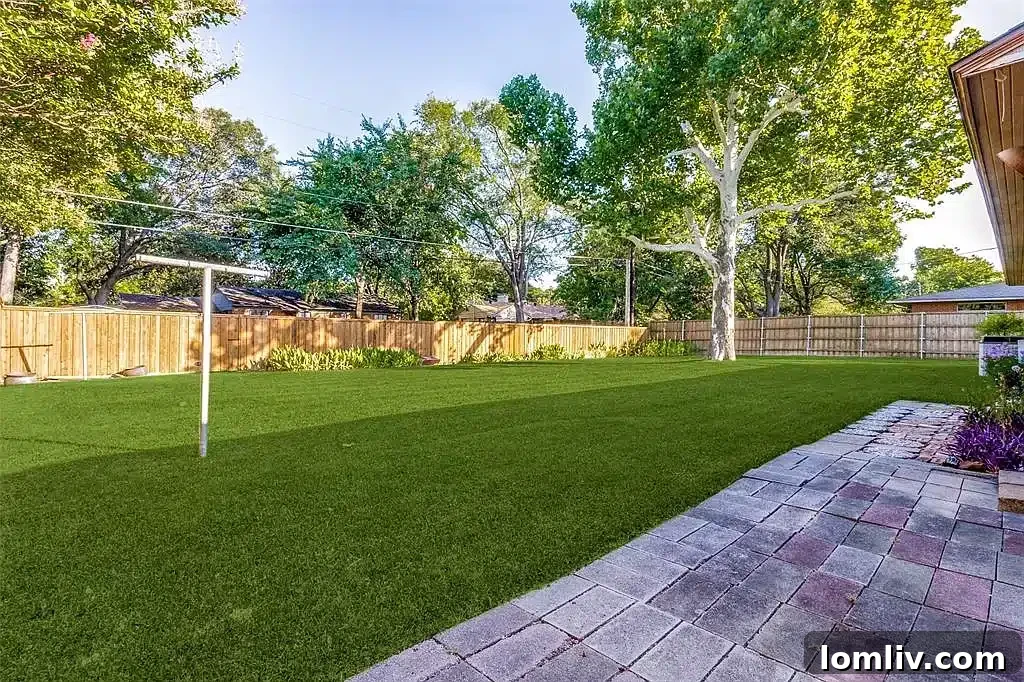 Expansive backyard with a lush lawn and privacy fence at 9922 Donegal Drive