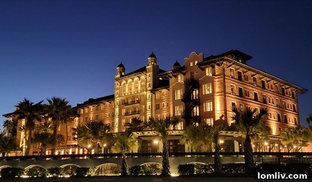 The Grand Galvez hotel illuminated at night, showcasing its stunning architecture.