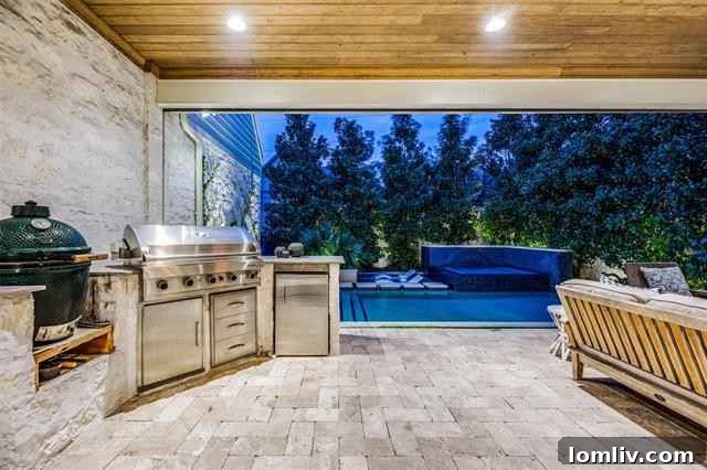 Covered outdoor loggia complete with a cozy fireplace and comfortable seating, ideal for year-round outdoor living and entertaining guests