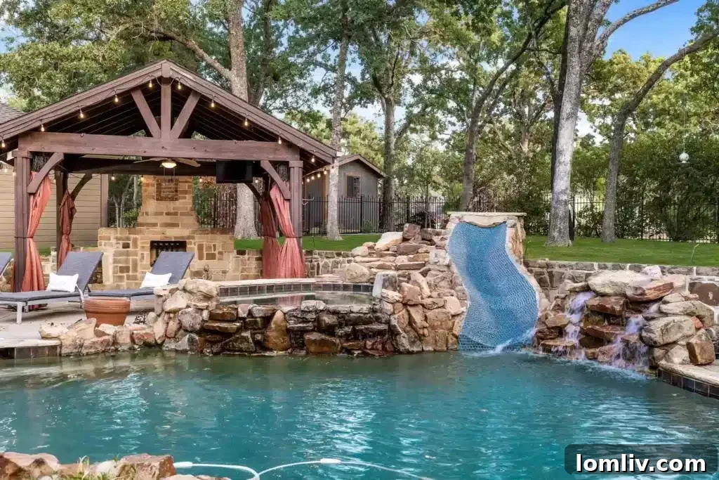 A Flower Mound Fairy Tale Home 13 Resort-Style Outdoor Living Area with Pool and Water Slide