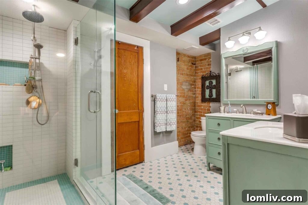 Luxurious master bathroom with freestanding sinks and rainfall shower