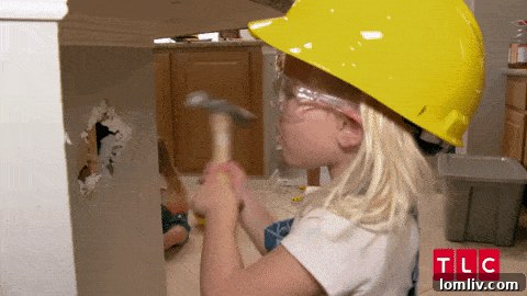 A determined construction worker wielding a jackhammer, breaking concrete