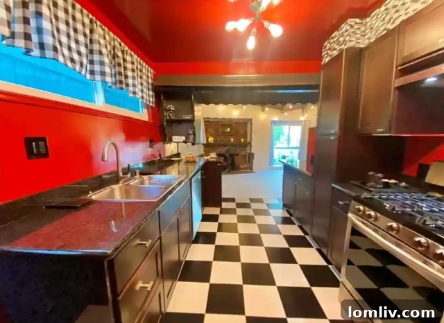 A closer view of the kitchen with its unique cabinets, bright countertops, and possibly a nod to arcade culture through its design elements.