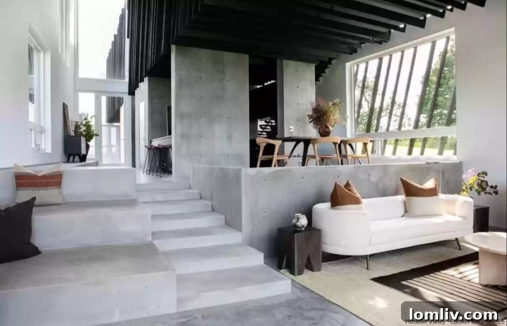 Modern living room with minimalist concrete seating and stark, contemporary decor.
