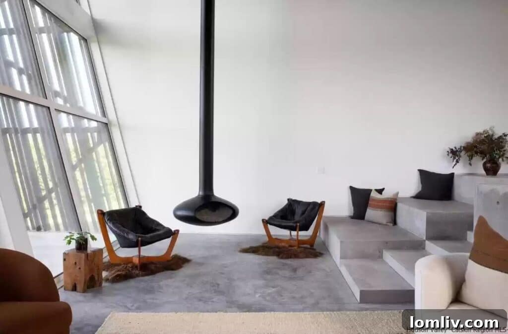 Industrial-chic interior with concrete walls, floor, and minimalist furniture in a luxury residence.
