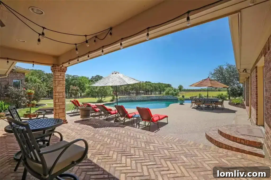Resort-Style Swimming Pool and Outdoor Dining Area at a Custom Home in Burleson, TX