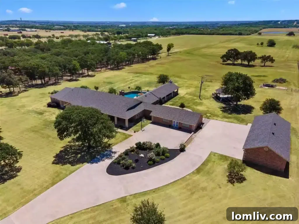 Expansive Two-Story Living Room with Vaulted Ceilings and Stone Fireplace in Burleson Luxury Home