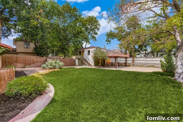 Own a Historic Hutsell Masterpiece in Lakewood 15 Stunning exterior view showcasing the Spanish Eclectic architecture and lush landscaping