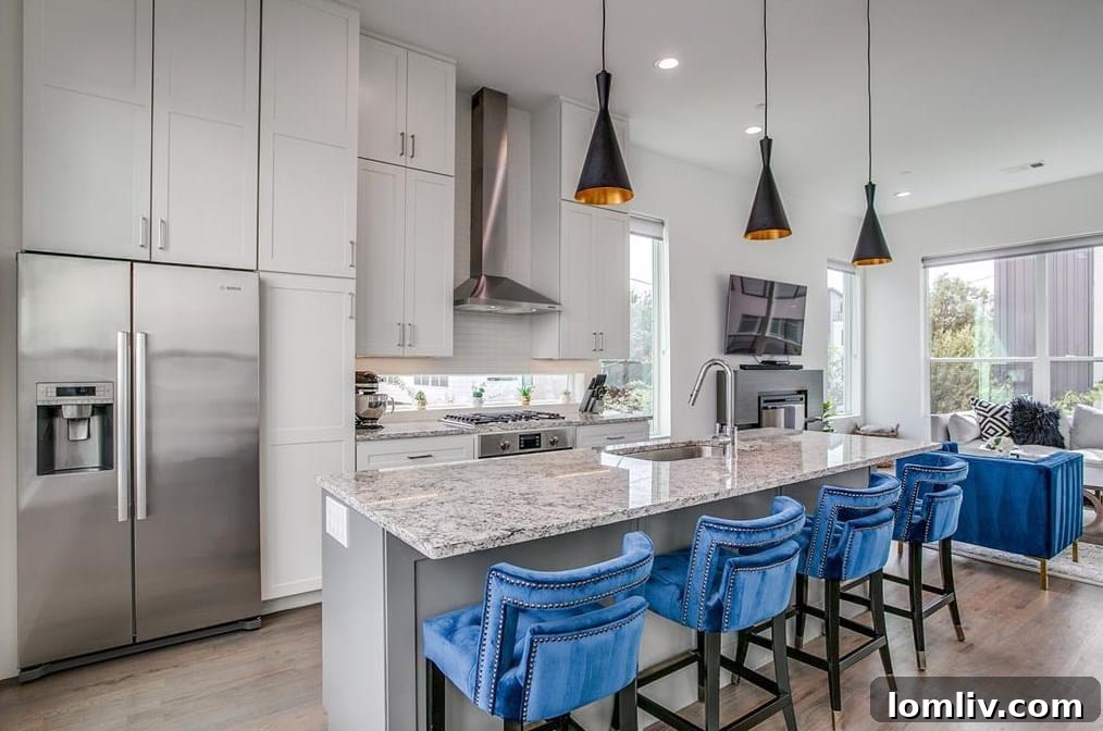 The Townhome That Captivates 7 Modern Kitchen with Stainless Steel Appliances and Island Bar