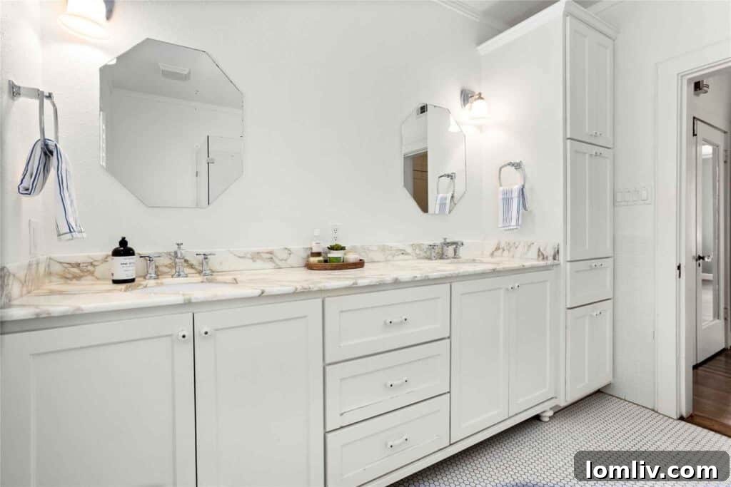 Luxurious Primary Bathroom with Sparkling Penny-Tile Floor and Retro Marble Countertops in a renovated 1926 villa