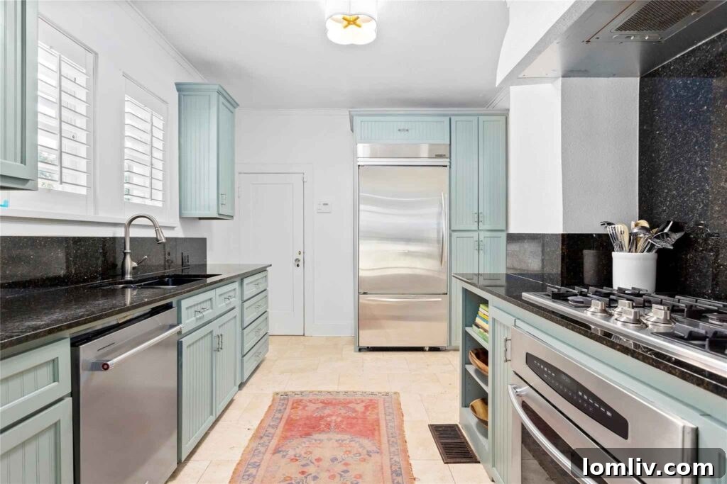 Modern Celadon Kitchen with Premium Gas Cooktop in a Renovated 1926 Villa, blending classic and contemporary styles