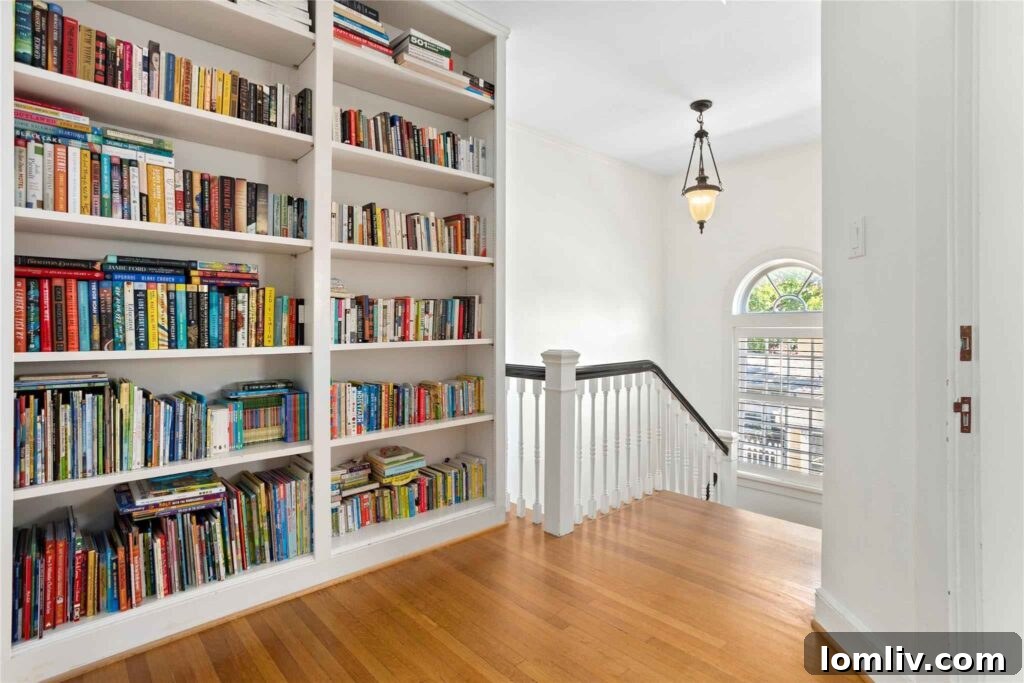 Elegant Staircase with Arched Window Leading to the Upper Level, showcasing historic charm