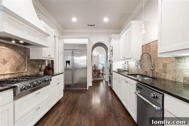 Open-concept kitchen connecting dining and family areas in a modern Brownstone