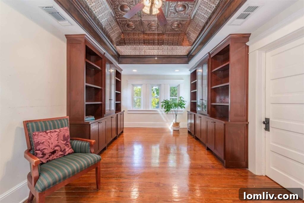Library landing with wet bar and coved ceiling with stamped tin tiles
