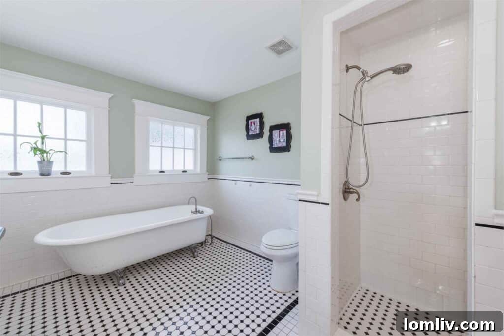 Upstairs bedroom with honey-colored hardwood floors and tray ceiling