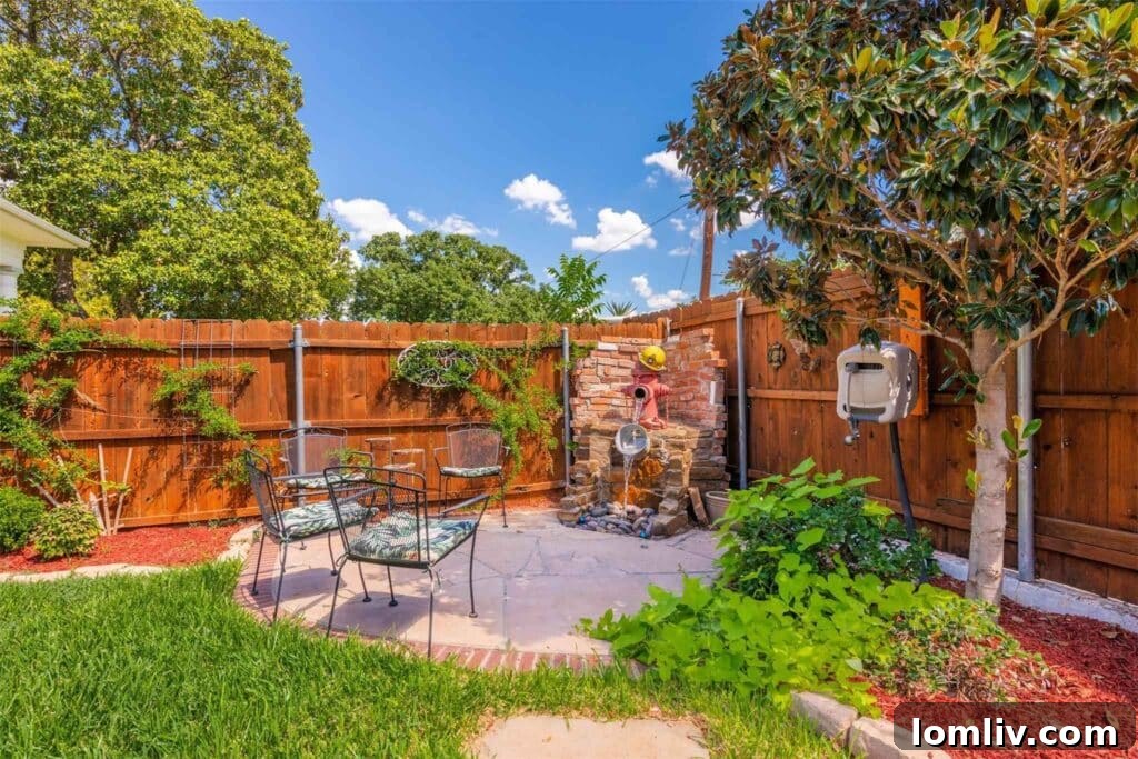 Charming back garden with paved patio and unique fire hydrant water feature