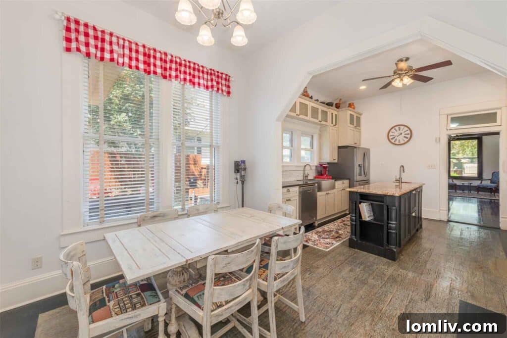 Spacious kitchen with black and pink granite countertops and gas range