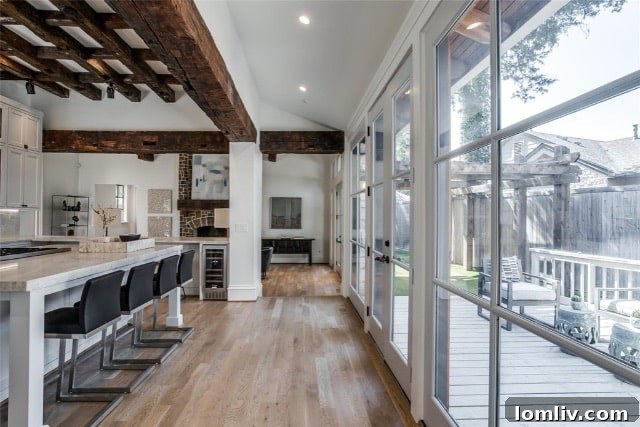 Spacious bedroom with wide plank wood flooring and neutral tones