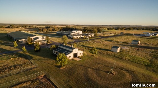 One of the multiple well-maintained horse barns, integral to the ranch's equine operations.