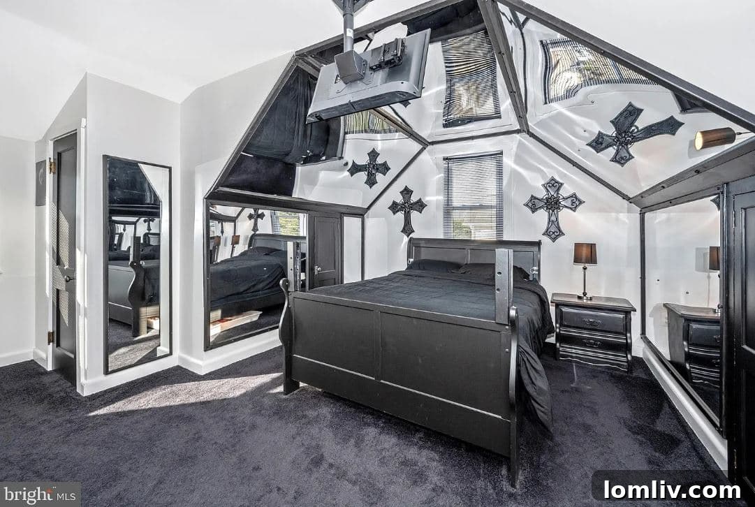 The master bedroom with mirrors encircling the bed, a church pew, and dark, thematic decor