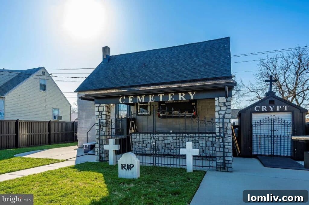 The backyard of the house, featuring an 'RIP' cross headstone and dark, gothic outdoor elements