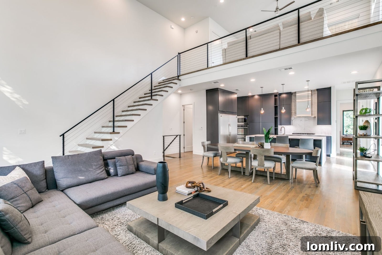 Elegant kitchen featuring a quartz waterfall island, high-end appliances, and ample counter space, perfect for entertaining.