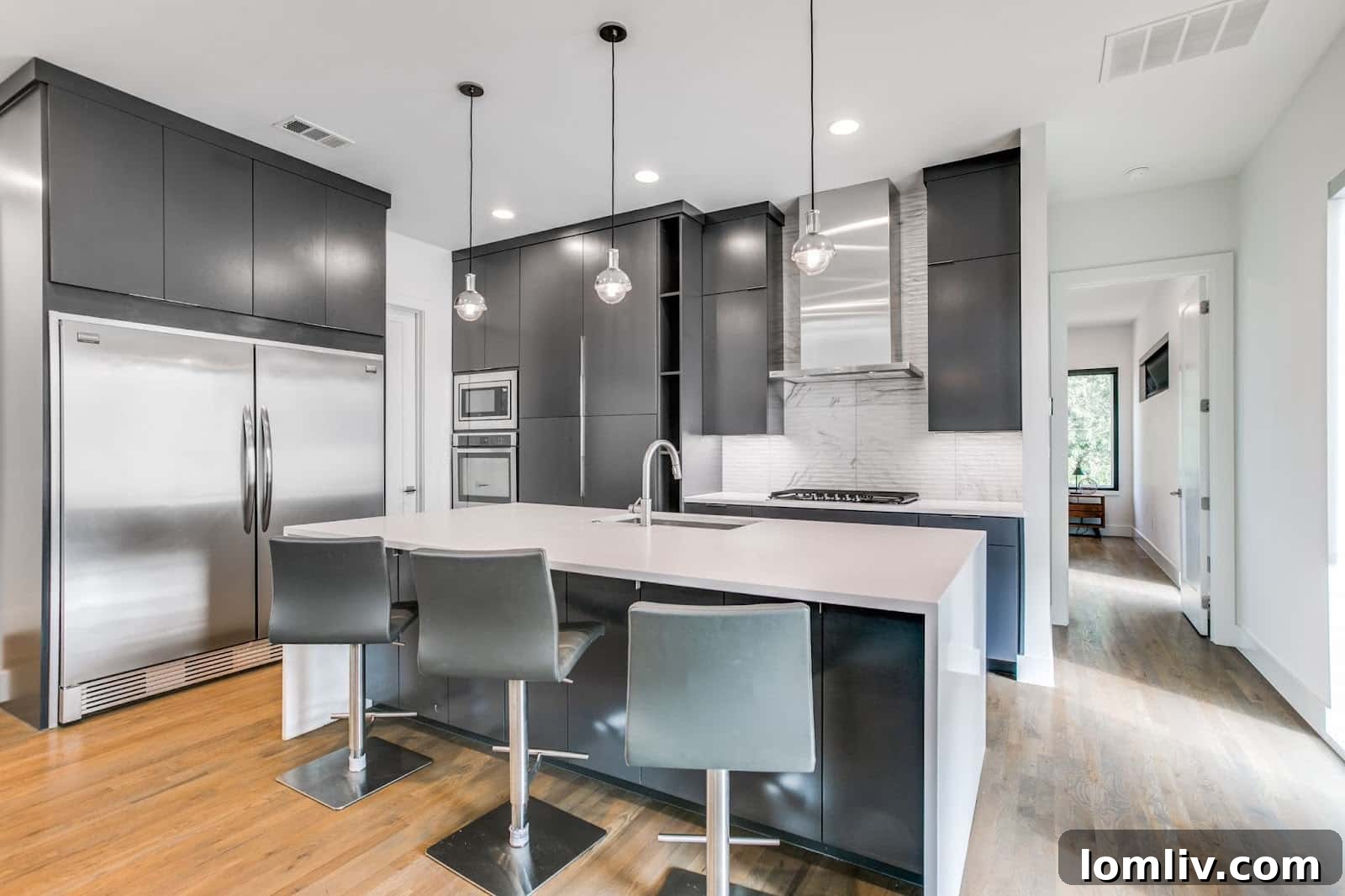 View of the open concept living and dining area, highlighting the seamless flow and natural light in the Manett St duplex.
