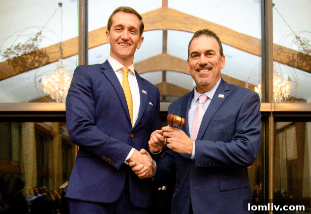 Andrew Pieper, outgoing Dallas Builders Association president, hands the ceremonial gavel to incoming 2022-2023 president John Porizek of M/I Homes of DFW.