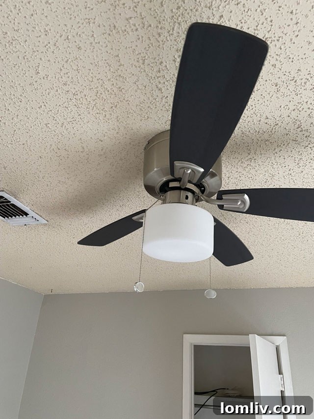 A ceiling fan blade found detached, lying on the floor, indicating a safety hazard.