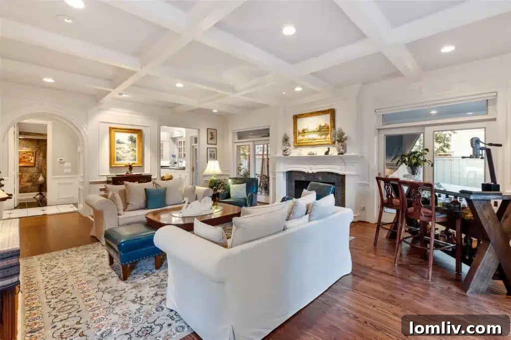 Spacious great room with cross-beamed ceiling and abundant natural light
