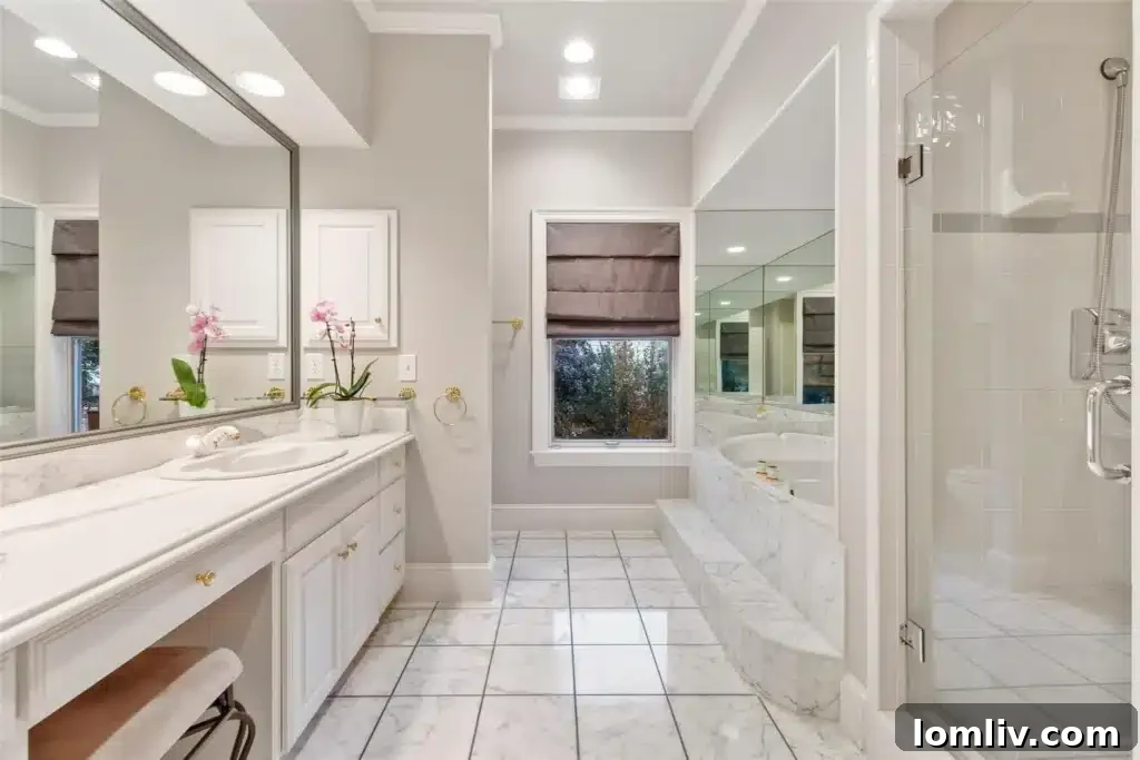 Luxurious primary bathroom with jetted tub and marble finishes