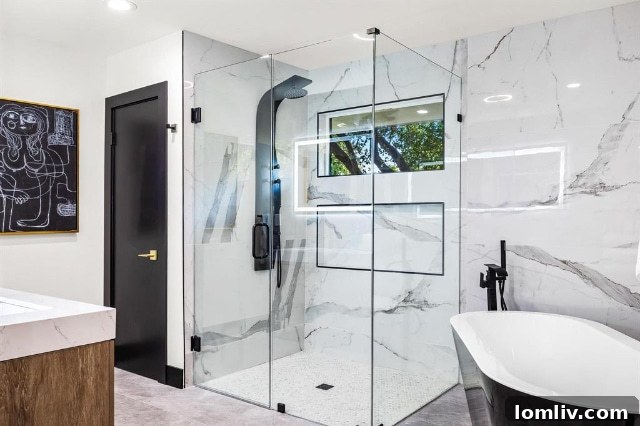 Luxurious walk-in shower featuring elegant tile work, a rain showerhead, and a sleek glass enclosure, offering a spa-like experience.