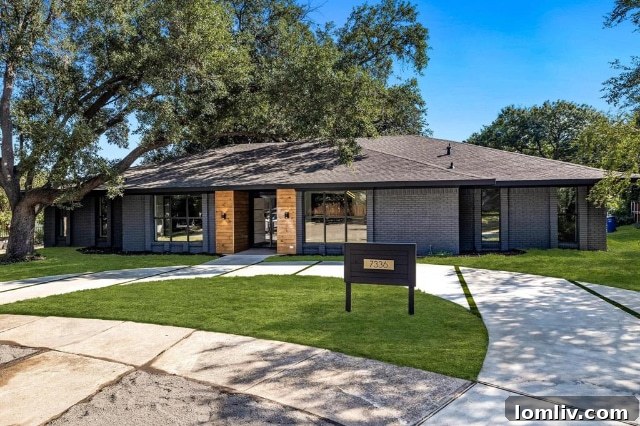 The inviting front facade of 7336 Lakehurst, showcasing the thoughtful landscaping and architectural details post-renovation.